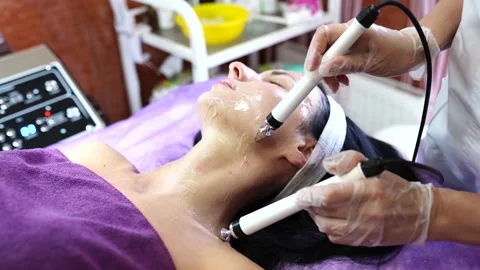 Cosmetologist dong the procedure of microcurrent therapy. beautician procedure Stock Footage 157055174