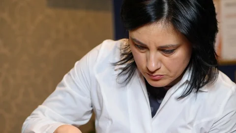 Cosmetologist is going face mask . peeling for young woman. Woman is having Stock Footage 86571803