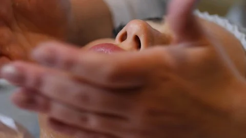 Cosmetologist is going face mask . peeling for young woman. Woman is having Stock Footage 86572486