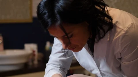 Cosmetologist is going face mask . peeling for young woman. Woman is having Stock Footage 86572737