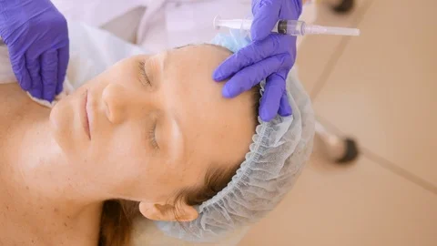The cosmetologist makes injections, anti-aging procedures for tightening and Stock Footage 107071353