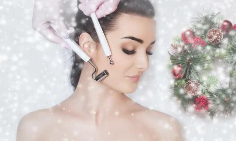 The cosmetologist makes the Microcurrent therapy procedure of a beautiful wom Stock Photos