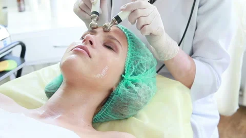 Cosmetologist makes the procedure microcurrent therapy Stock Footage 97437127