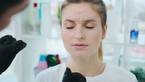 Cosmetologist making eyebrow permanent makeup Stock Footage 157316206