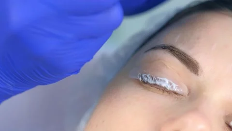 Cosmetologist making lash laminating and eyebrow painting for woman in clinic. Stock Footage 136874192