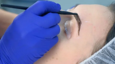 Cosmetologist making lash laminating and eyebrow painting for woman in clinic. Stock Footage 136874301