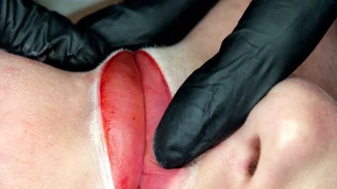 Cosmetologist making lips microblading permanent procedure using tattoo machine Stock Footage 138921489