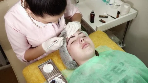 Cosmetologist is making a microblading procedure in beauty salon Stock Footage 74356027