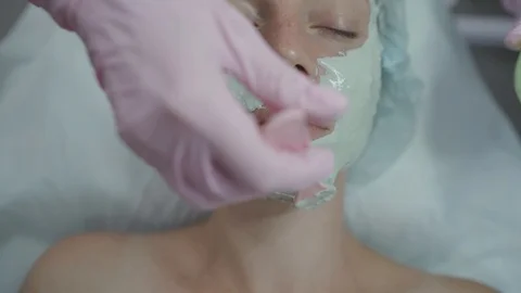 Cosmetologist in the office do procedures to the gir Stock Footage 102463665