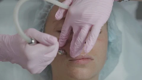 Cosmetologist in the office do procedures to the gir Stock Footage 102464655