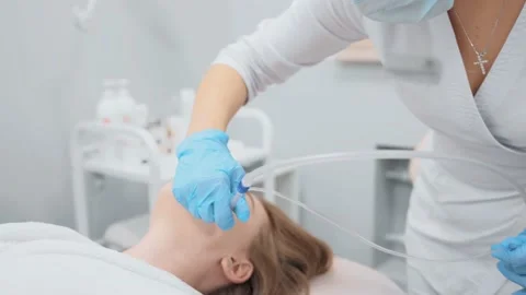 Cosmetologist performs a gas-liquid peeling procedure - rejuvenation and Stock-Footage 230183175