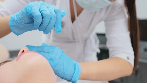 Cosmetologist performs a gas-liquid peeling procedure - rejuvenation and Stock-Footage 230183295