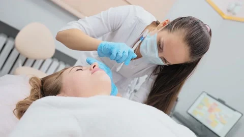 Cosmetologist performs a gas-liquid peeling procedure - rejuvenation and Stock-Footage 232596261