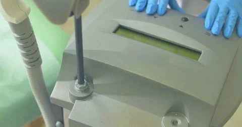 Cosmetologist preparing laser epilation device to working. Start working Stock Footage 92114549