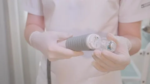 Cosmetologist  puts a nozzle on the device Stock Footage 157082358