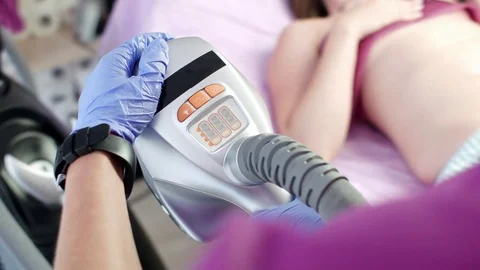 Cosmetologist sets machine for massage Stock Footage 78507440