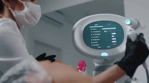 Cosmetologist using laser device with touchscreen interface Video stock 311156241