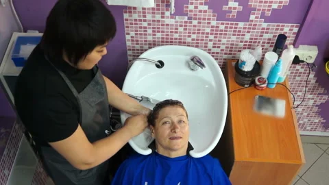 Cosmetologist washes the woman's head Stock Footage 87450609