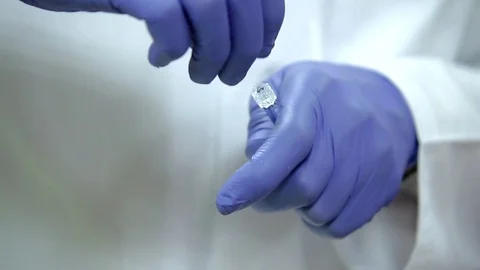 Cosmetologist in white coat open container with serum Stock-Footage 75608762