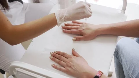 A cosmetologist's hand rejuvenation procedure using an air stream Stock Footage 266891066
