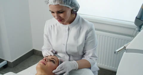 Cosmetology. Closeup Of Female Face having facial treatment in beauty salon Stock Footage 152563353