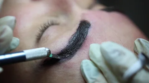 Cosmetology procedure: Eyebrows Microblading black paint Stock Footage 75369137