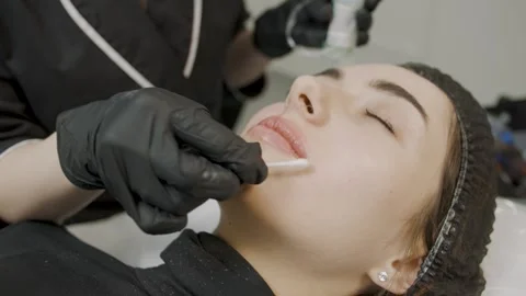 Cosmetology process showcasing slow motion application of permanent makeup Stock Footage 319827568