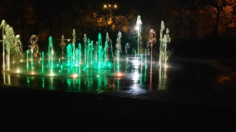 Cosmopolis colorful singing fountain in Torun at night Stock Footage