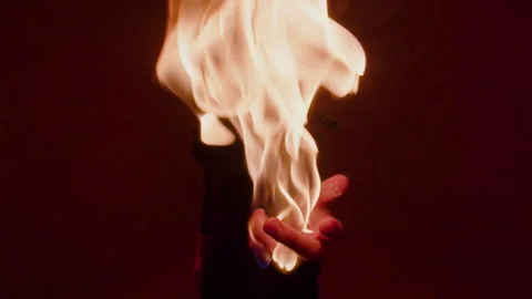 Cosplay wizard with a sword behind his back, burning hand. Real fire on the Stock Footage 133188243