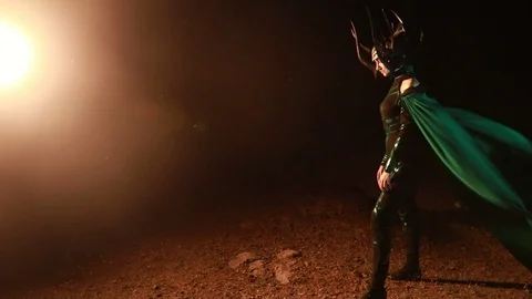 Cosplayer portrays goddess Hela in fluttering cloak. Stock Footage 115039894