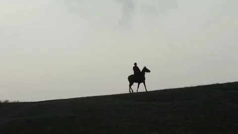 Cossack on horseback galloping over the hill Stock Footage 71436757