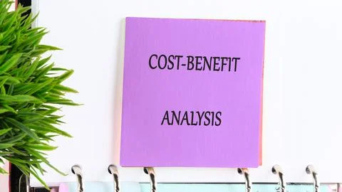 Cost-benefit analysis notes displayed in an office setting during a morning.. Stock Photos