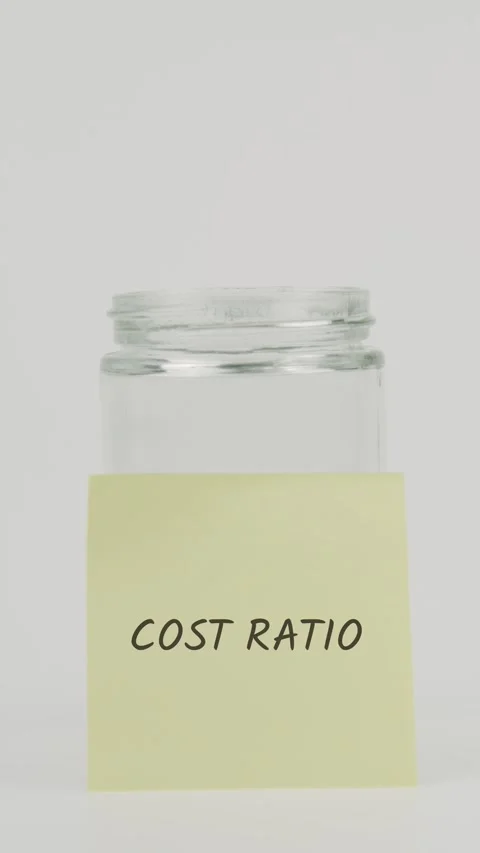 Cost ratio text or word on yellow sticky note attached to glass jar with Stock Footage 311700676