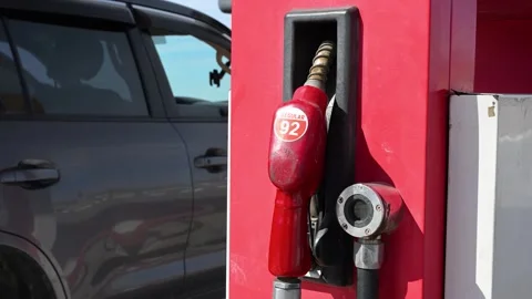 The cost of travel: A close-up on a Regular 92 octane gasoline pump at a remote Stock Footage 317675530