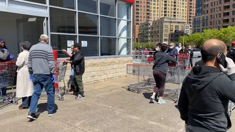 Costco customers wait in Lines to enter due to COVID-19 restrictions Stock Footage 127680675