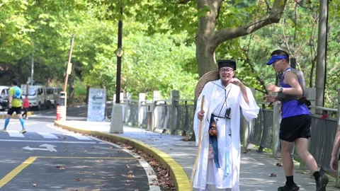 Costume Character Waving to Trail Runner in Forest, Lushan Event Stock Footage 346733206