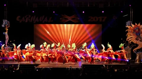 A costumed dance company performs during transfer of powers of Aguilas Carnival Видео 73429509