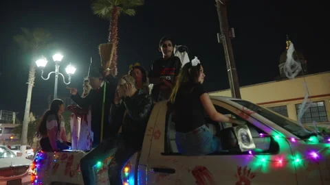Costumed people riding on decorated pickup truck during Day of the Dead parade. Stock Footage 337909367