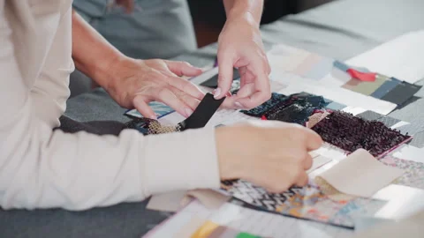 Costumer matching black fabric sample to skin tone during selection process Stock Footage 307135897