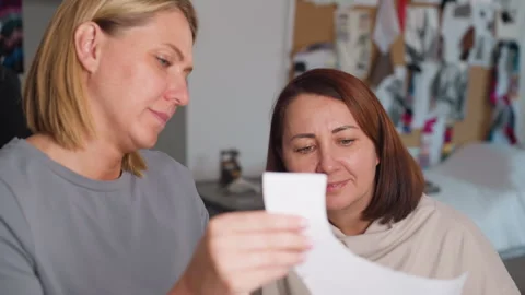 Costumer Showing Paper Pattern to Friend Smiling in Workshop Stock Footage 307136181