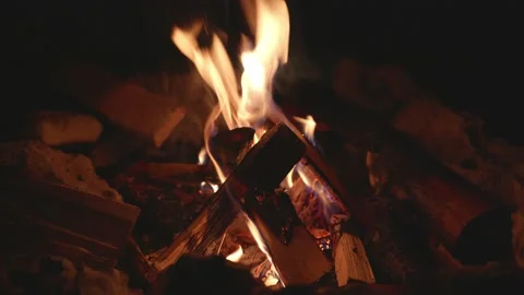 Cosy campfire in the night with dancing flames, sparks and cracking noises Stock Footage 157678709