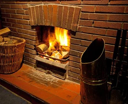 A cosy roaring log fire Stock Photos