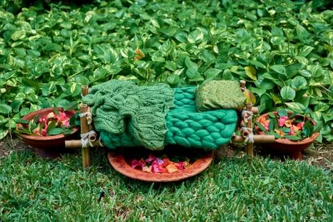 The cot is made of bamboo and tableware made of clay in garden. Stock Photos