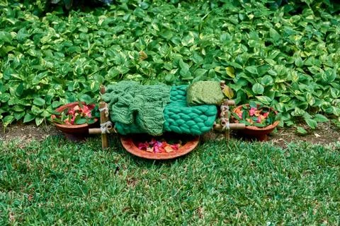 The cot is made of bamboo and tableware made of clay in garden. Stock Photos