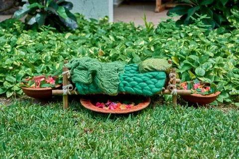 The cot is made of bamboo and tableware made of clay in garden. Stock Photos