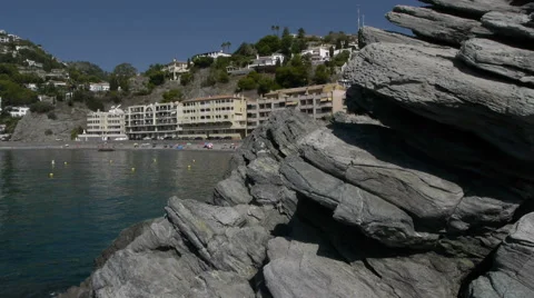 Cotobro beach past the camera by rocks Stock Footage 41578460
