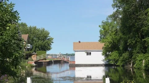 Cottage with a boathouse and small bridge Stock Footage 52304582