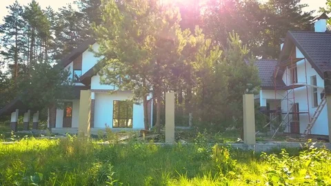 Cottage building construction aerial hard natural flares Stock Footage 79293265