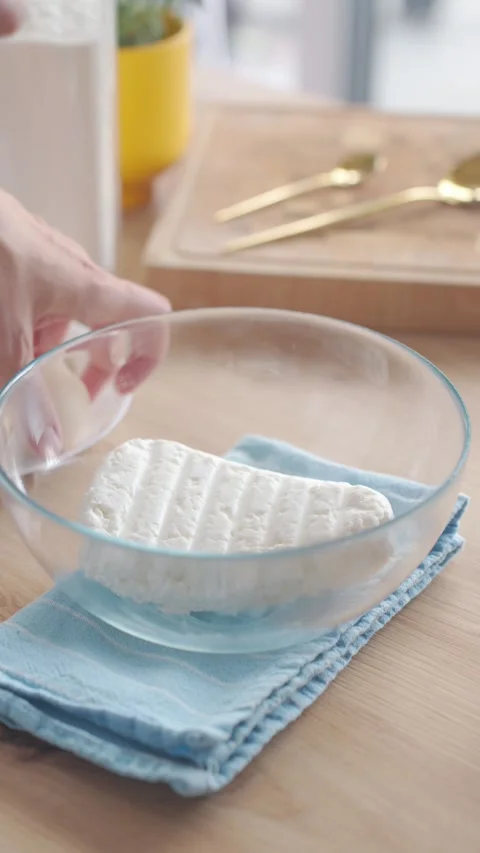 Cottage cheese is added to plate before cracking egg into it Stock Footage 336863520