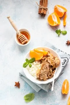 Cottage cheese with apple crumble served with tangerine, mint and honey. Stock Photos